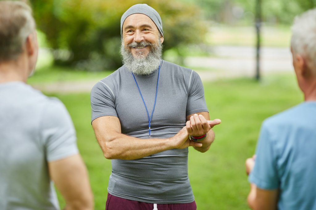 Aged Trainer Checking Heart Beat