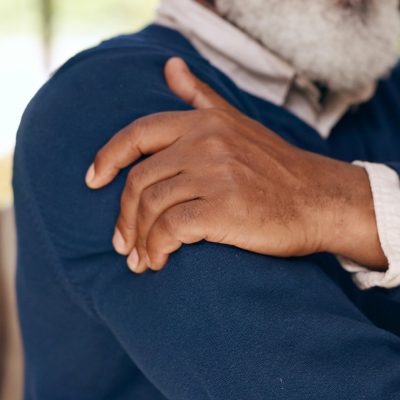 Senior man, hands and shoulder with pain in home from arthritis, osteoporosis and tired joints, mus